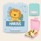 Light blue personalised kids lunch box with a lion picture and the name Harris, and a pink lunch box open to show its compartments