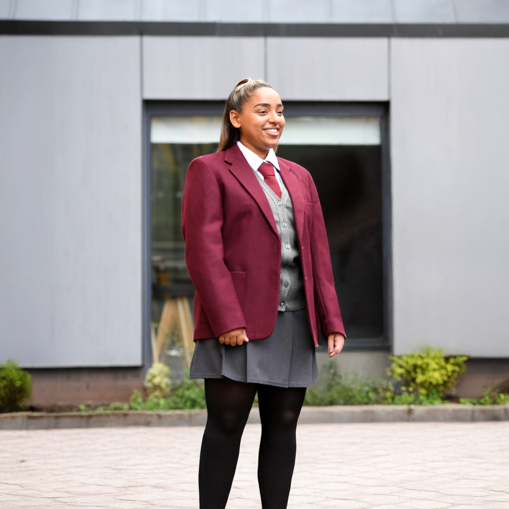 Lifestyle Image of Student Wearing Grey Henley Pleated Skirt by Banner