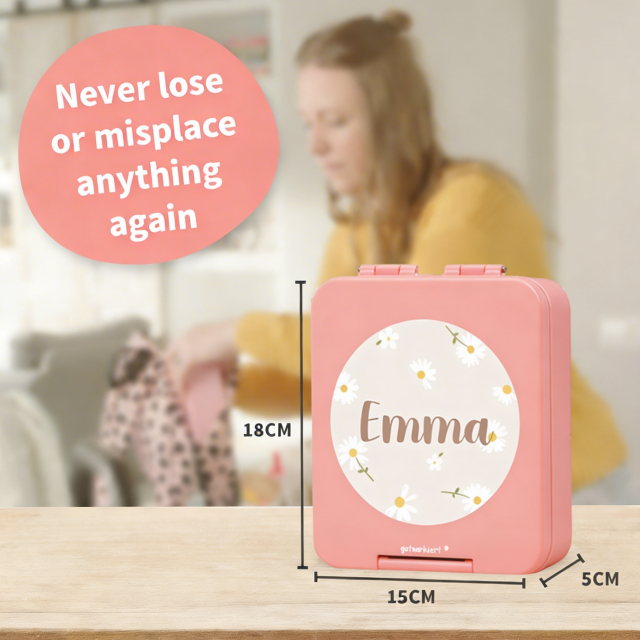 Pink personalised Emma daisy design lunch box, 18 x 15 x 5 cm, on a kitchen worktop