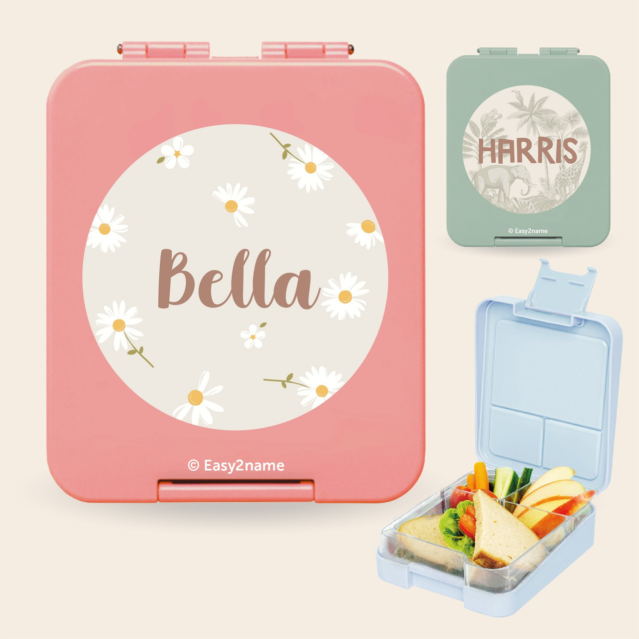 Pink personalised lunch box with daisies and the name Bella, a green lunch box named Harris and an open box with compartments
