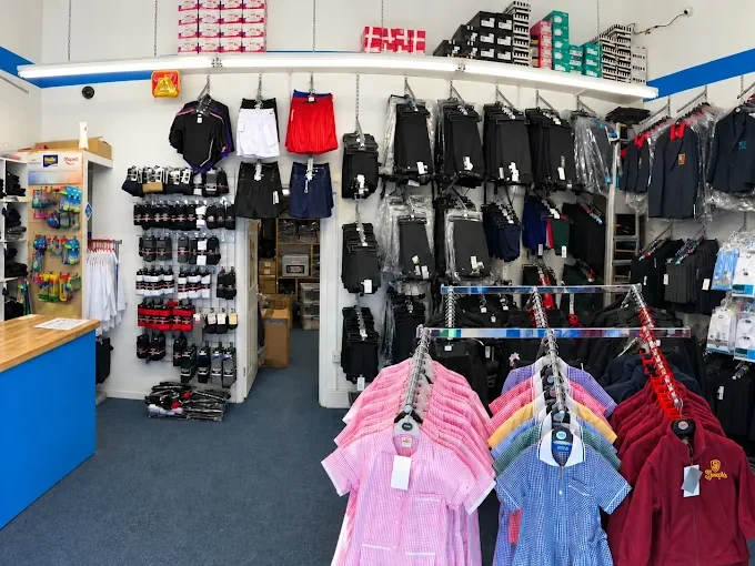 Inside the West Norwood shop: school shirts, shorts, PE kit and socks on the walls, with gingham dresses and school jumpers on the rails