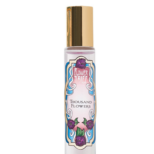 Closeup of Thousand Flowers Perfume rollerball. This fragrance contains Freesia, Magnolia, Peony, Gardenia, Jasmine and Lilac. Flower Thief perfume line is manufactured by Elixery.