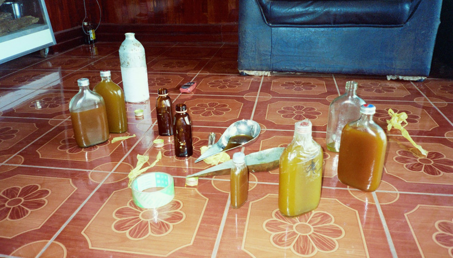 Buying a bottle our Oud oil in Laos, late 1990s--the tradition was to try the oil, then tape the bottle cap and write your name on it, so no one could tamper with it overnight--security