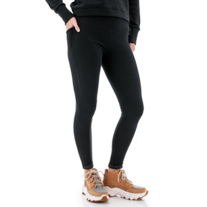 Side view of woman wearing black Aventura Clothing Dog Walker Fleece Legging, showing pocket detail.