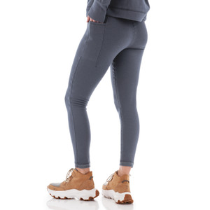 Back view of woman wearing grey Aventura Clothing Dog Walker Fleece Legging paired with boots.