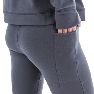 Close-up of grey Aventura Clothing Dog Walker Fleece Legging fabric, showing hand in side pocket.