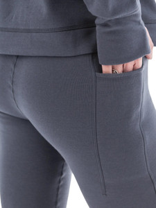 Close-up of grey Aventura Clothing Dog Walker Fleece Legging fabric, showing hand in side pocket.