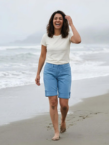 Woman walking on beach wearing Arden V2 Short in cindre blue.