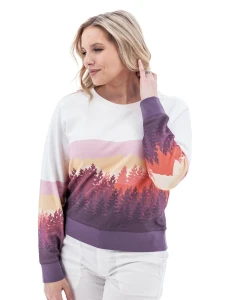 Side view of woman in white Aventura Clothing Alpine Glow Sweatshirt with pink, orange, and purple sunset print.