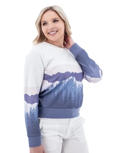 Side view of woman in white Aventura Clothing Alpine Glow Sweatshirt with blue and purple forest sleeve print.