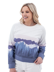 Woman wearing white Aventura Clothing Alpine Glow Sweatshirt with blue and purple mountain silhouette print.