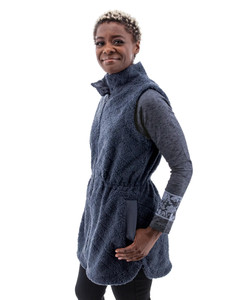 Detail view of the Solstice Sherpa Vest showing a side pocket with rib-knit welt trim and the internal drawstring at the waist for an adjustable, cinched fit.