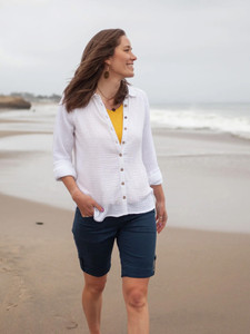 Woman walking on beach wearing Kelford Full button raglan long sleeve in white