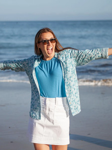 Woman standing on beach wearing Isla Raglan Sleeve Top in cinder blue