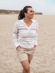Woman walking on beach wearing Bindi Beach Johnny Collar Sweater in Natural Stripe color