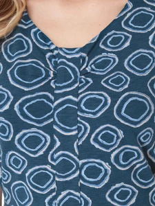 Close-up of Aventura Clothing Cali Fit & Flare Printed Dress bodice showing v-neck and blue geometric circle print.