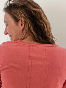Upper neck and shoulder detail of the Salem Micro Henley Scoop Neck Top in faded rose red.