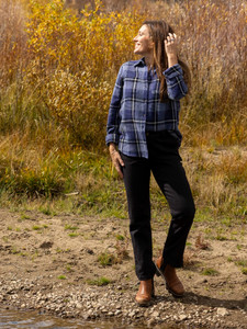Woman standing outdoors during fall wearing the Brackenridge Organic Cotton Shirt in cobalt blue plaid.