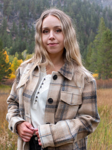 Woman outside during fall wearing the Ivycroft Waffle Knit Henley Top in whisper white.