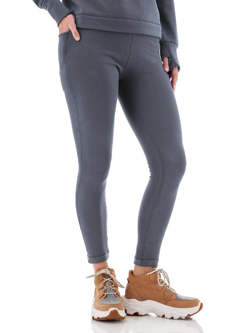 Side view of woman wearing grey Aventura Clothing Dog Walker Fleece Legging, showing pocket detail.