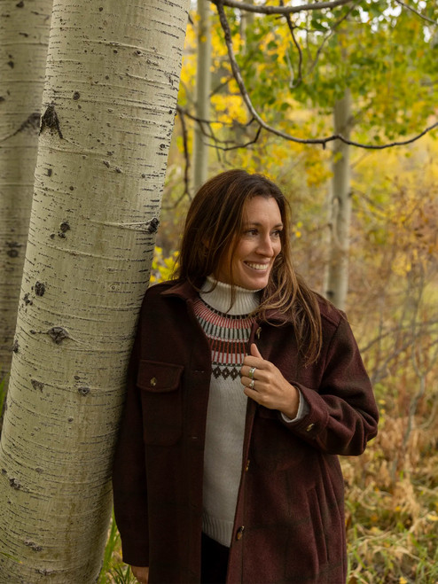 Woman standing outdoors during fall wearing the Northern Wind Car Coat in mahogany brown.