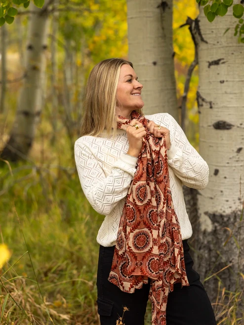 Woman wearing Medallion Scarf in bordeaux color outdoors during fall.