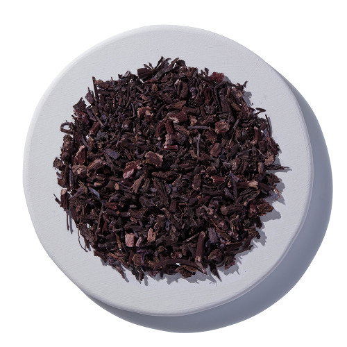 Alkanet Root Cut and Sifted Wildcrafted on a white plate