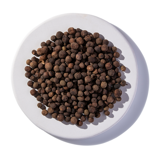 Allspice Whole Organic on a white plate