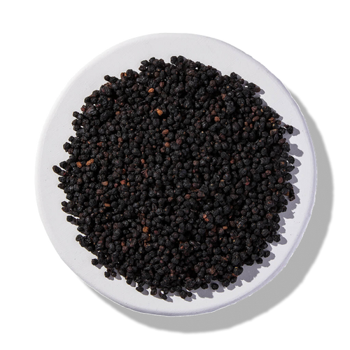 Organic dried elderberries on a white plate