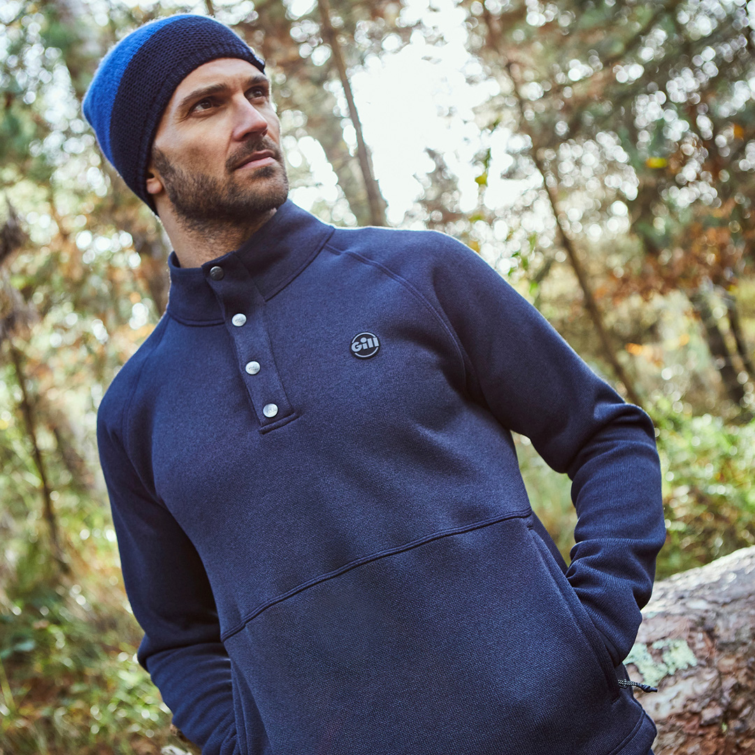 Man in the woods wearing a Gill Fisher Fleece 