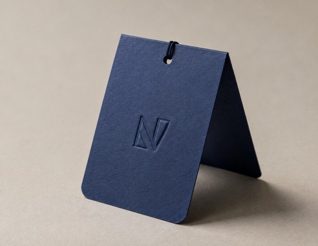 Blind embossed hang tags on navy folded cardstock | printshaQ