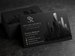 Black business cards with a minimalist monogram design printed in white ink on smooth matte black stock — printshaQ.com