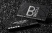 Black suede business cards with silver foil stamping and spot UV lamination, a premium matte black finish from printshaQ.com