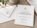 Custom invitation printing shown on a table beside its envelope — a flat full-color invitation card with clean typography, the format used for weddings, showers, openings, and corporate events.