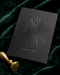 Raised spot UV greeting card in matte charcoal cardstock with a glossy sunburst pattern and "Thank You" lettering, styled with a gold wax seal on emerald velvet.