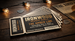 Die cut ticket-shaped flyer for Ironwood Music Hall's 'The Amber Line,' printed on black stock with a perforated stub, fanned out on a rustic wood table with warm string lights — custom die cut flyer example