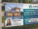 Custom mesh banner promoting a real estate open house, printed in full color with wind-resistant perforated vinyl that holds up outdoors near the property entrance.