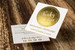 Elegant gold foil stamped business cards with a large metallic circular design that creates a clean, modern and luxurious appearance.