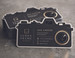 Camera-shaped die cut business card designed for photographers and photography studios. This custom die cut shape signals your profession at a glance, printed on premium black cardstock with gold foil accents. A standout die cut option for photography branding.