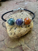 Ash bead bracelet shown with three beads.  Blue, purple and cinnamon. Price increases with added beads. 