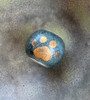 The 22K gold presents as the glaze does. Blue is a matte glaze, the gold will present a matte finish.