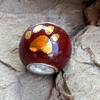 22K gold paw print presents as the glaze does. Deep Red is a glossy glaze, the 22K gold paw print will present as glossy.