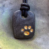 Matte Black Kona with 22K gold paw print. The ash is safely contained during the process of hand making this bead. There will be slight variances in shape, no molds are used.  Each paw print is hand formed. A layer of gloss glaze is applied to the paw print during the first glaze firing. This makes each paw print appear glossy weather it is on a glossy glaze or a matte glaze.