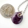 Glossy Purple Sisu Beads Cremation Ash Necklace.  The ash really gets highlighted with the purple glaze. This glaze has lots of variations when fired.