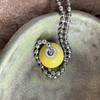 Yellow glaze shown on stainless steel ball chain.