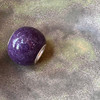 Purple glossy cremation ash bead.