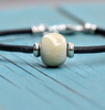 Glossy Birch. Okalani bracelet has a cremation ash bead with a sterling silver core,  black leather bracelet with sterling silver accents and clasp.  Each bracelet is custom made to your wrist size. 