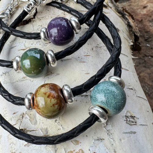 Malama, cremation ash bead bracelet by Sisu Beads. Colors top to bottom,  Purple, Green, Terra and Blue.