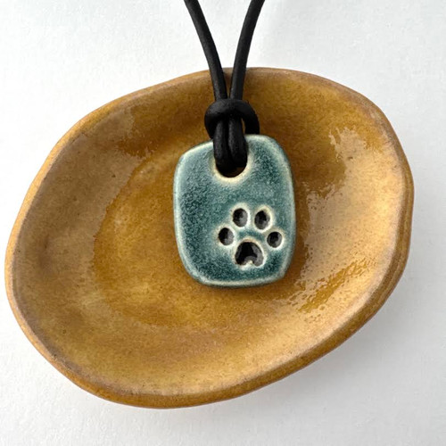 Paw print Kona memorial bead. Honoring pets. Blue matte glaze, minimal variations. Paw print Kona memorial bead. Honoring pets. Blue matte glaze, minimal variations.