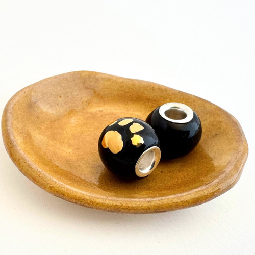 Hand made and painted. 22K gold paw print bead. Fits Pandora. Paw print on Glossy Black glaze. The gold paw print will present glossy when over a glossy glaze and matte over a matte glaze